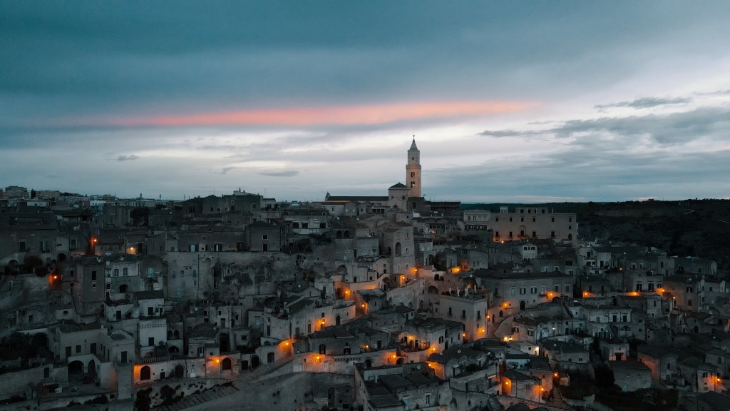 Ripresa con drone su Matera illuminata all'alba